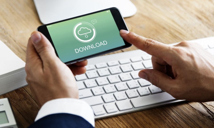 Finger tips on a Smartphone with download screen on it